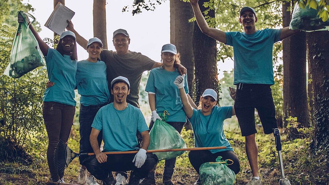 Foto: junge Menschen mit Mülltüten in den Händen - Freiwilligendienst im Ausland
